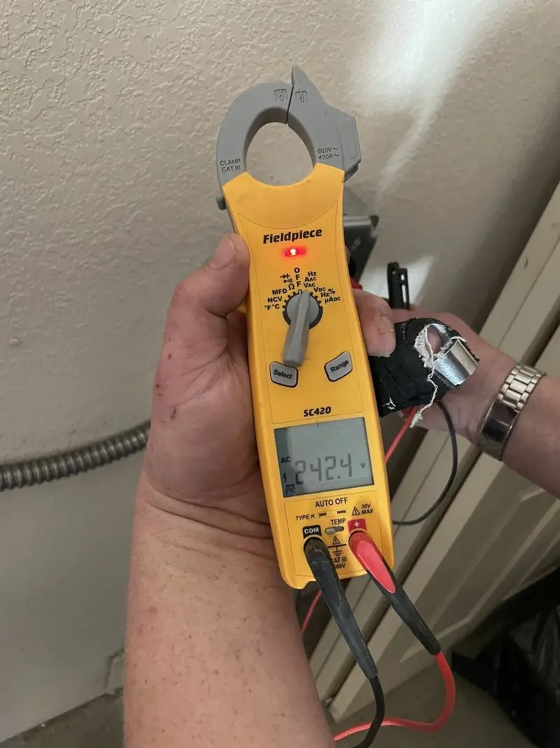 Voltage testing with clamp meter during Recessed Lighting Installation in Lehman